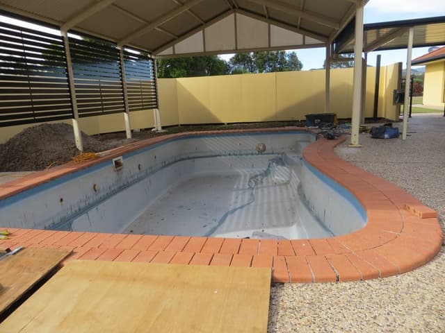 Fibreglass pool before assessment  -  surface damage visible
